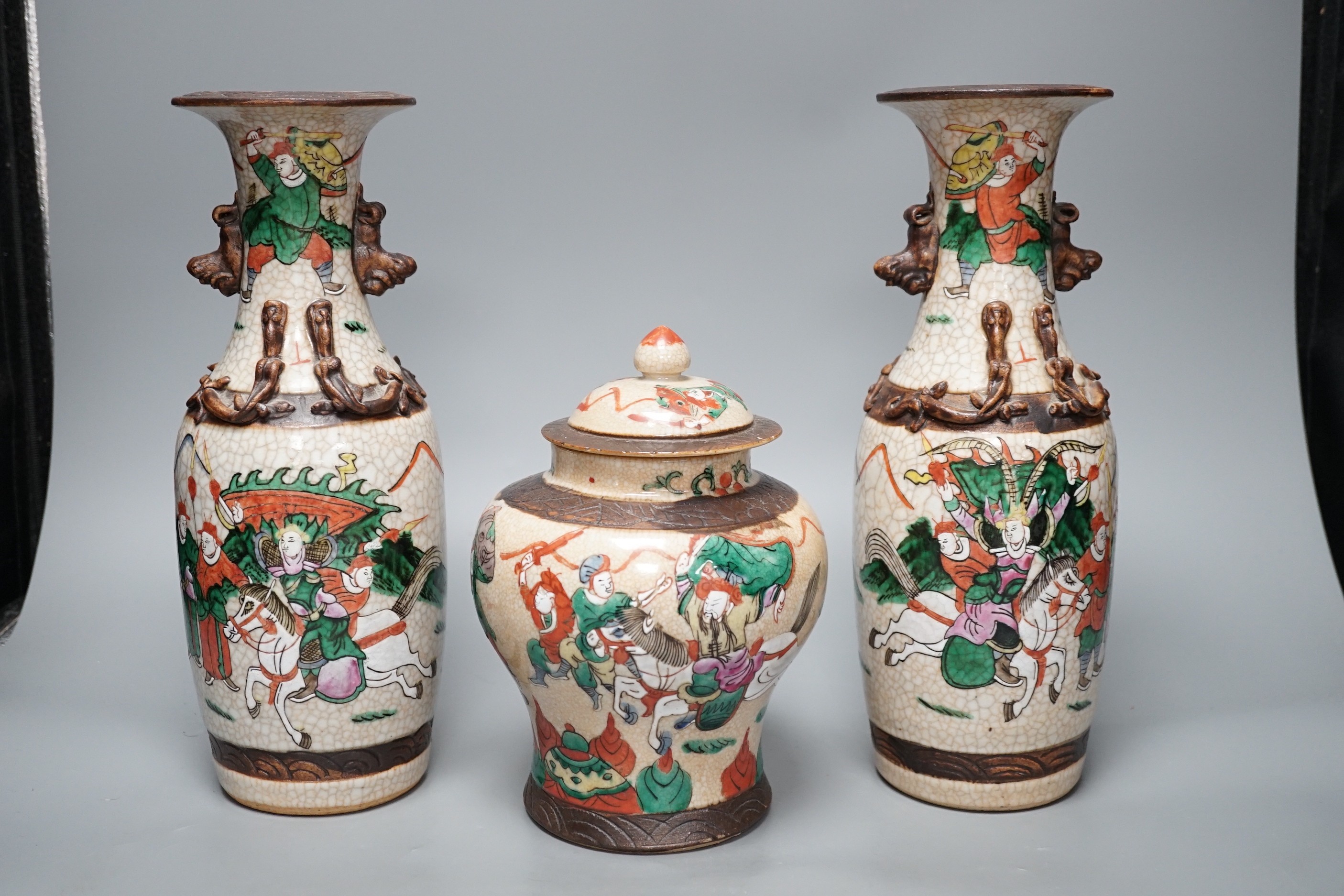 A pair of late 19th century Chinese crackle glaze vases and a similar vase and cover, tallest 29.5cm